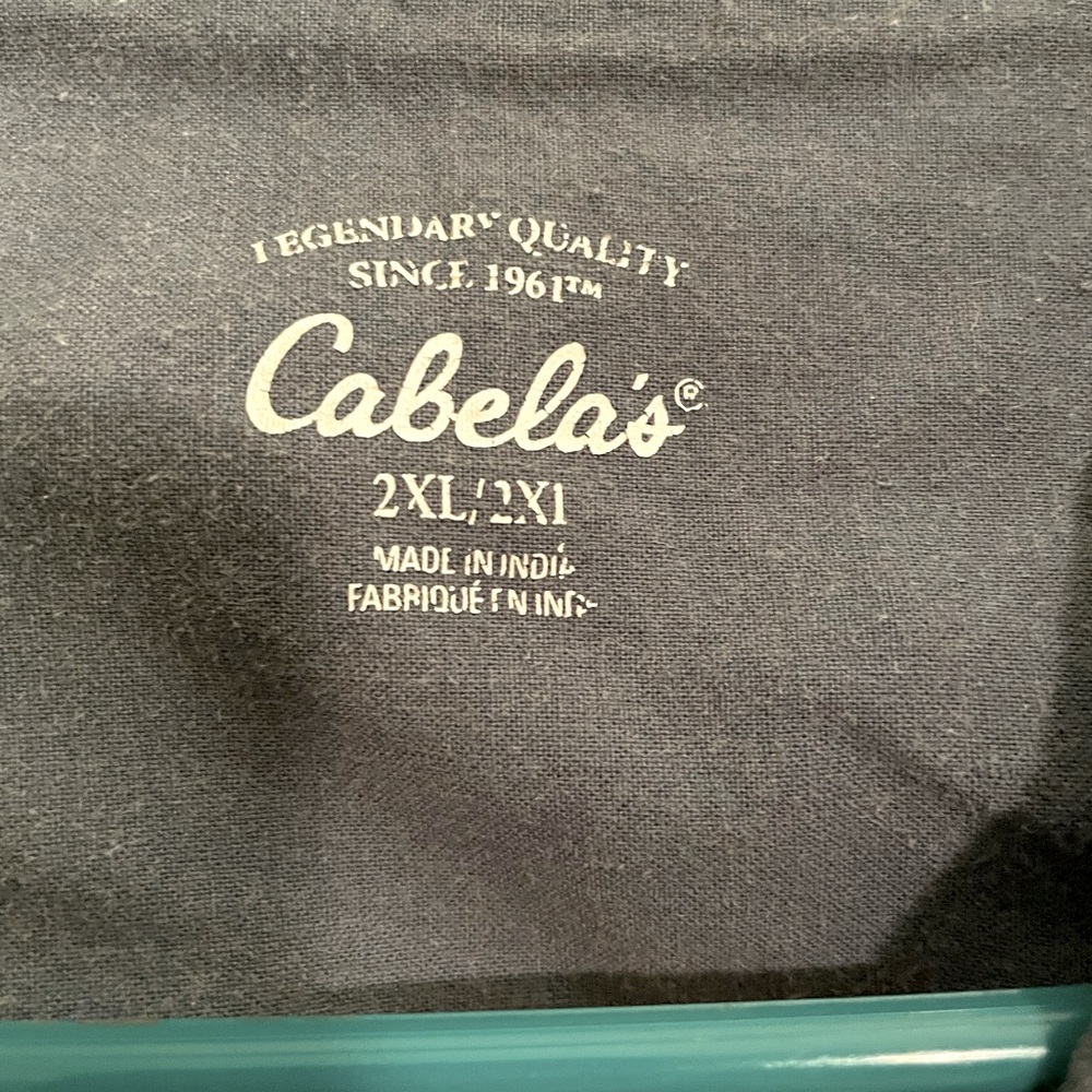 Cabela’s size 2x button up light purple, light blue, and white stripes.